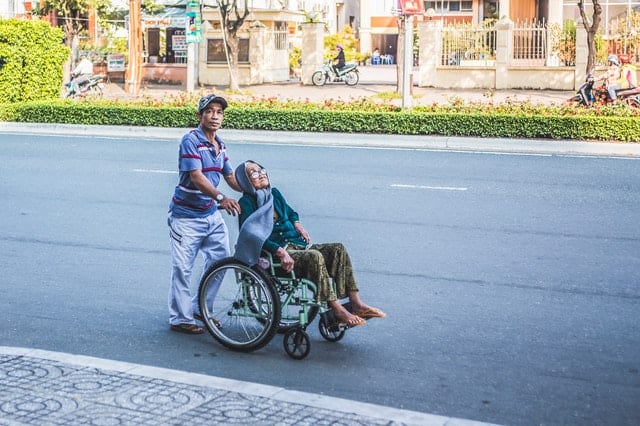 old woman in wheelchair with her caretaker